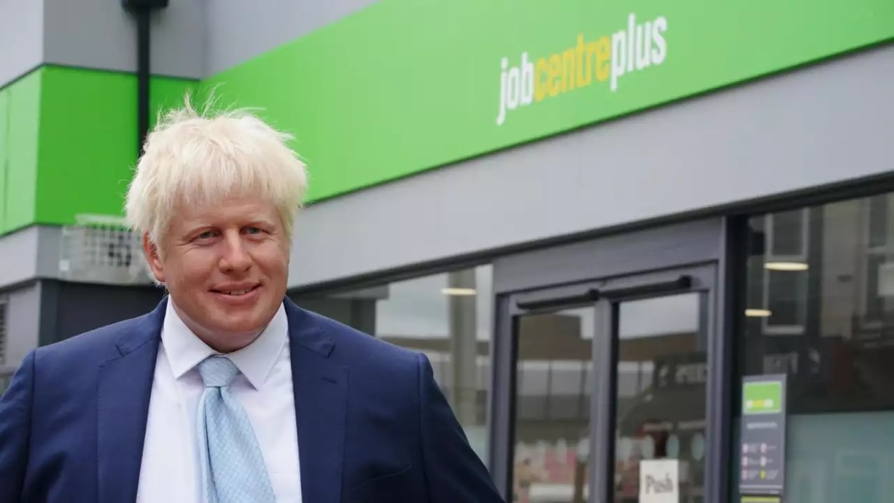 Boris Johnson’s wax statue, created by Madame Tussauds, displays in front of a job-seekers centre.